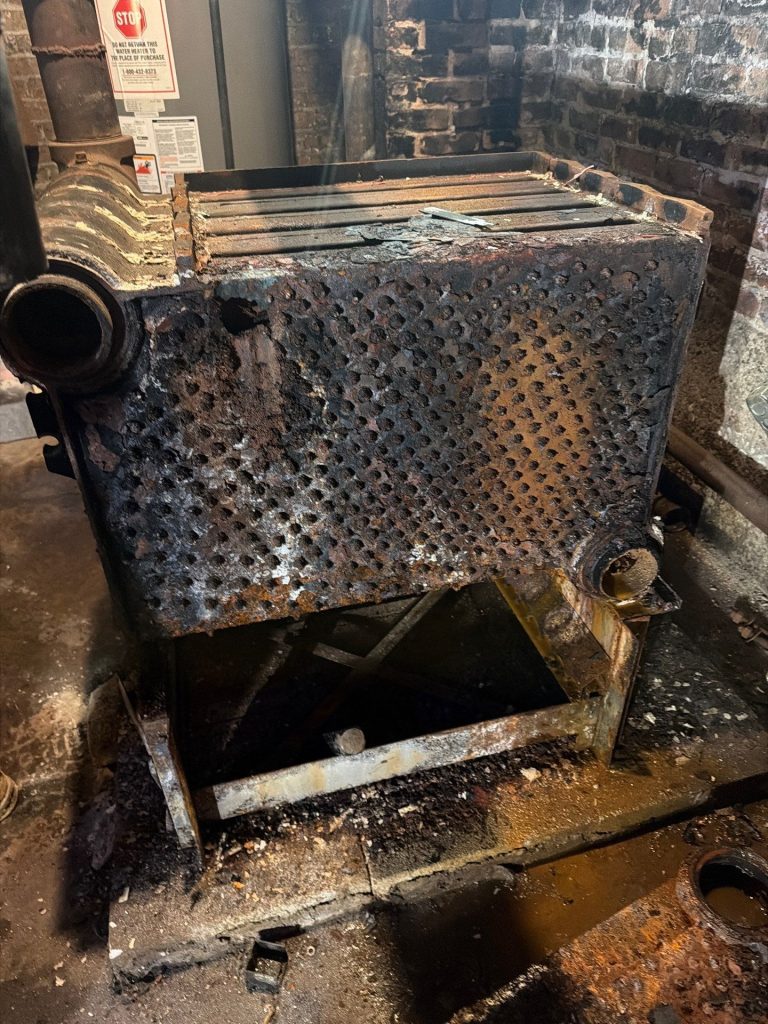 Rusted, corroded cast-iron section removed from the old steam boiler
